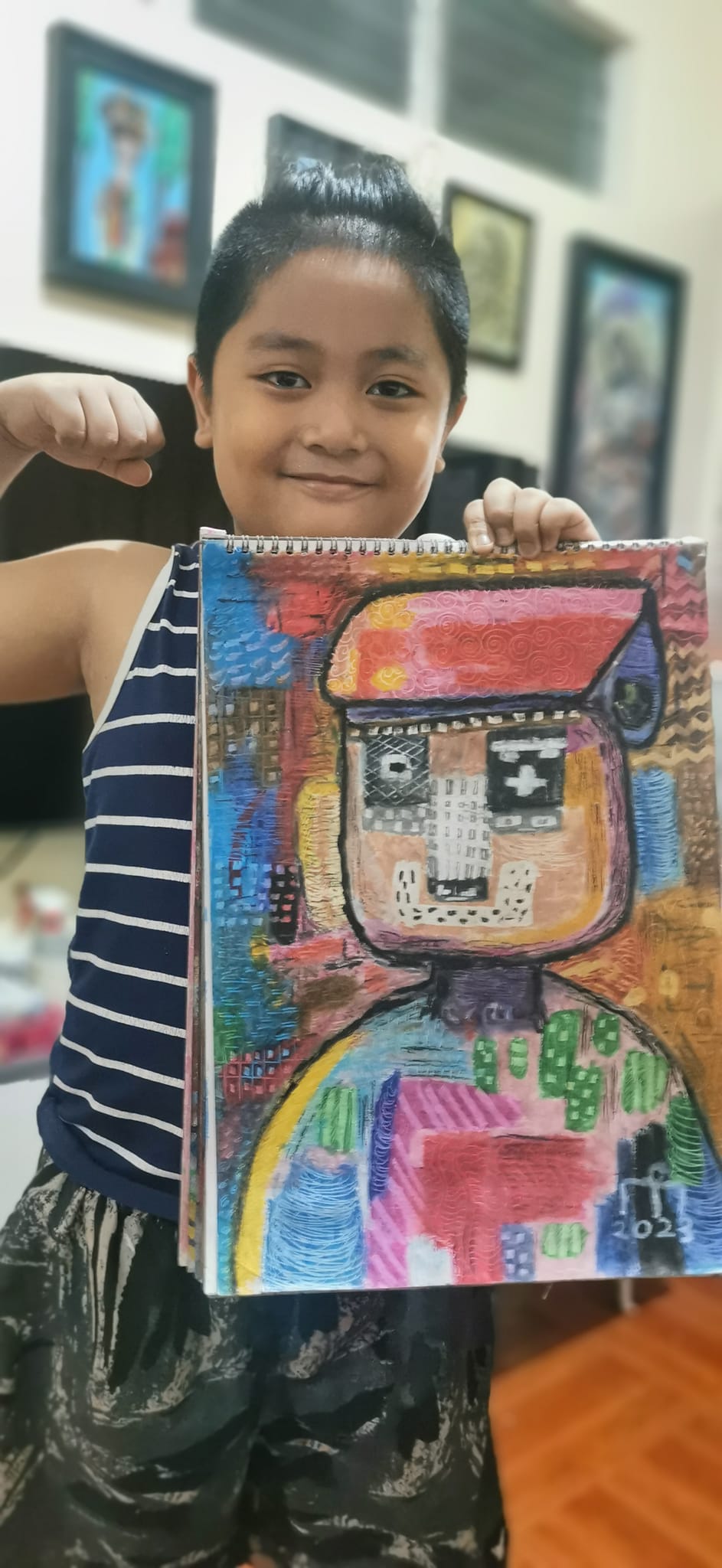 Elmo proudly presents one of his abstract paintings. (Photo by Ennsar Luis Modelo)